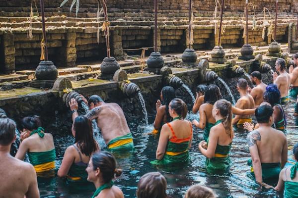 People doing a purification ceremony at a temple in Bali.